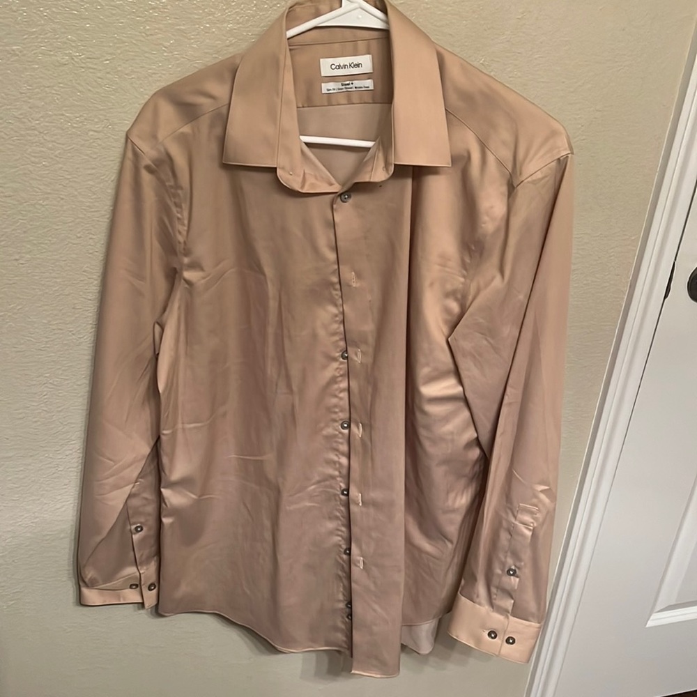 It’s a tan colored Calvin Klein wrinkle free large shirt! Slim fit